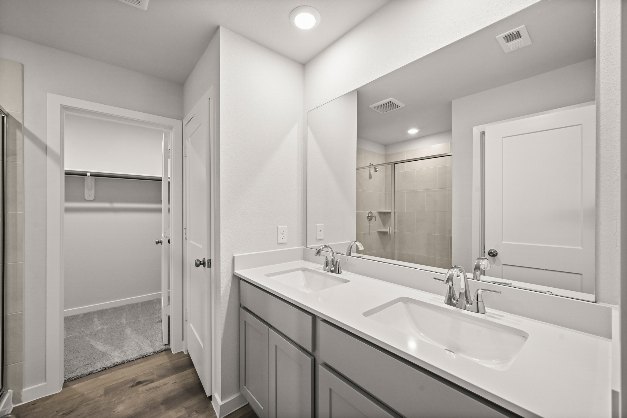 A bathroom with a large mirror.