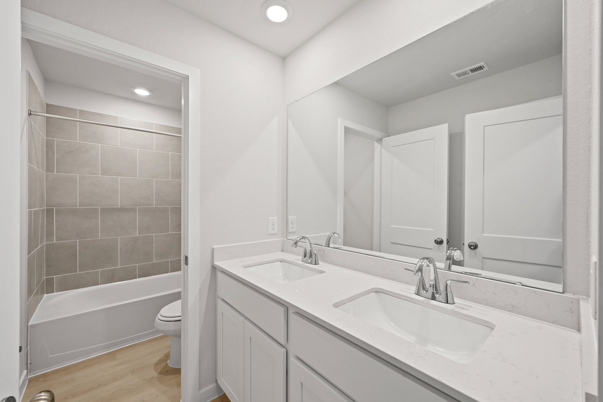 A bathroom with a tub sink and toilet.