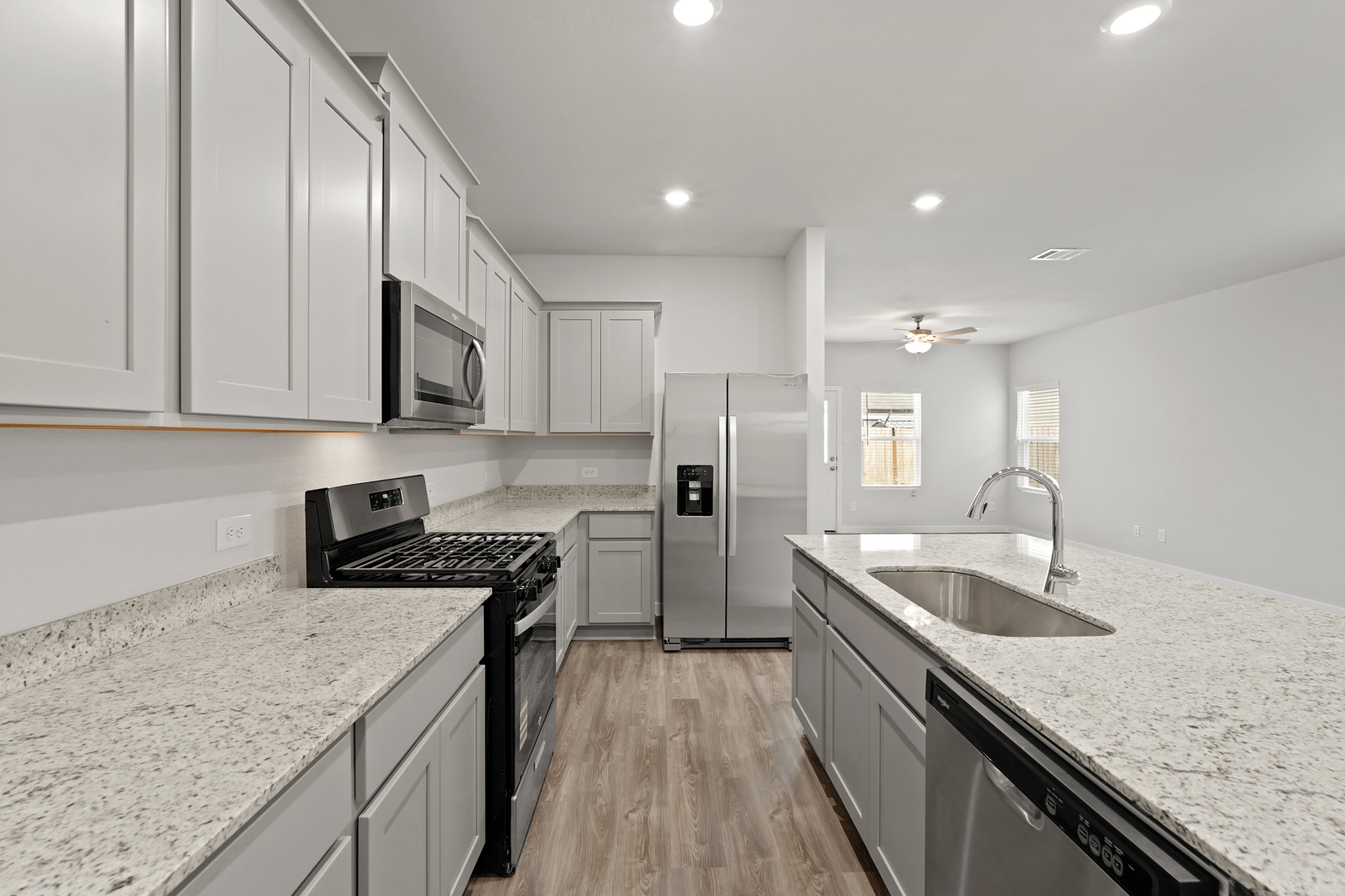 A kitchen with white cabinets.