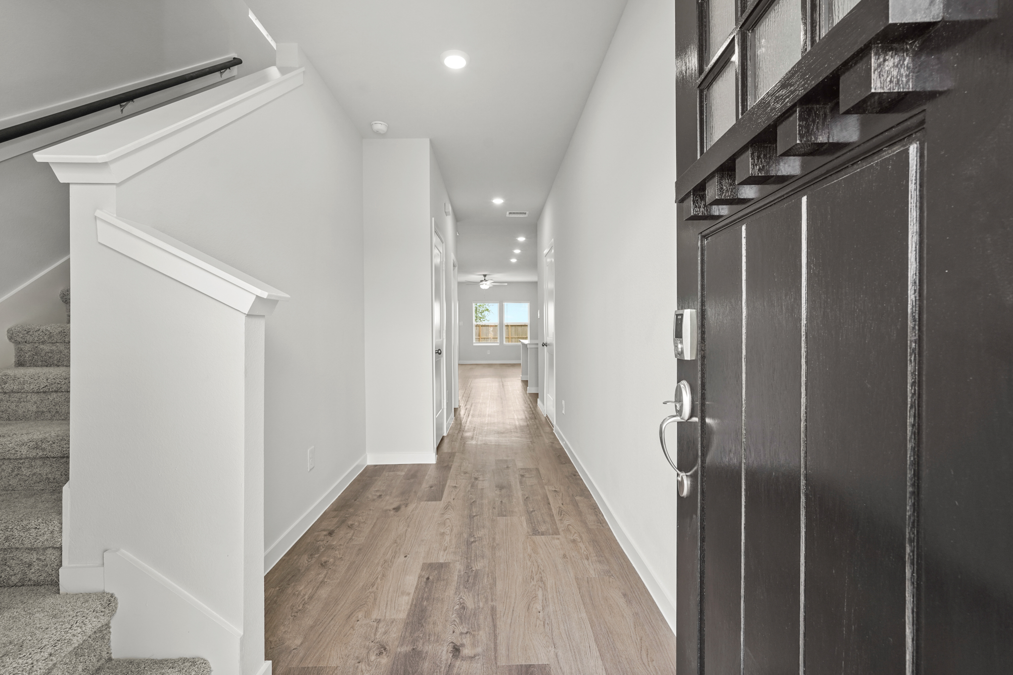 A hallway with a wood floor.