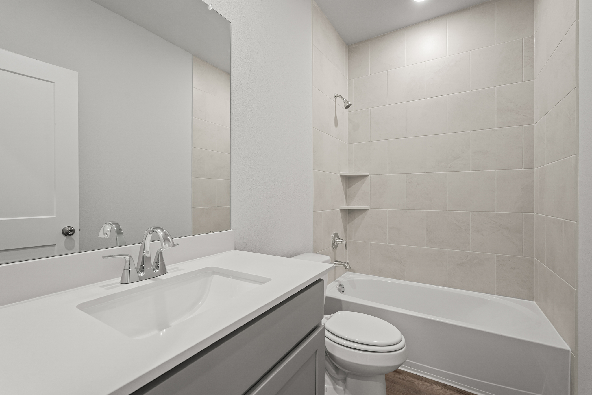 A bathroom with a sink toilet and bathtub.