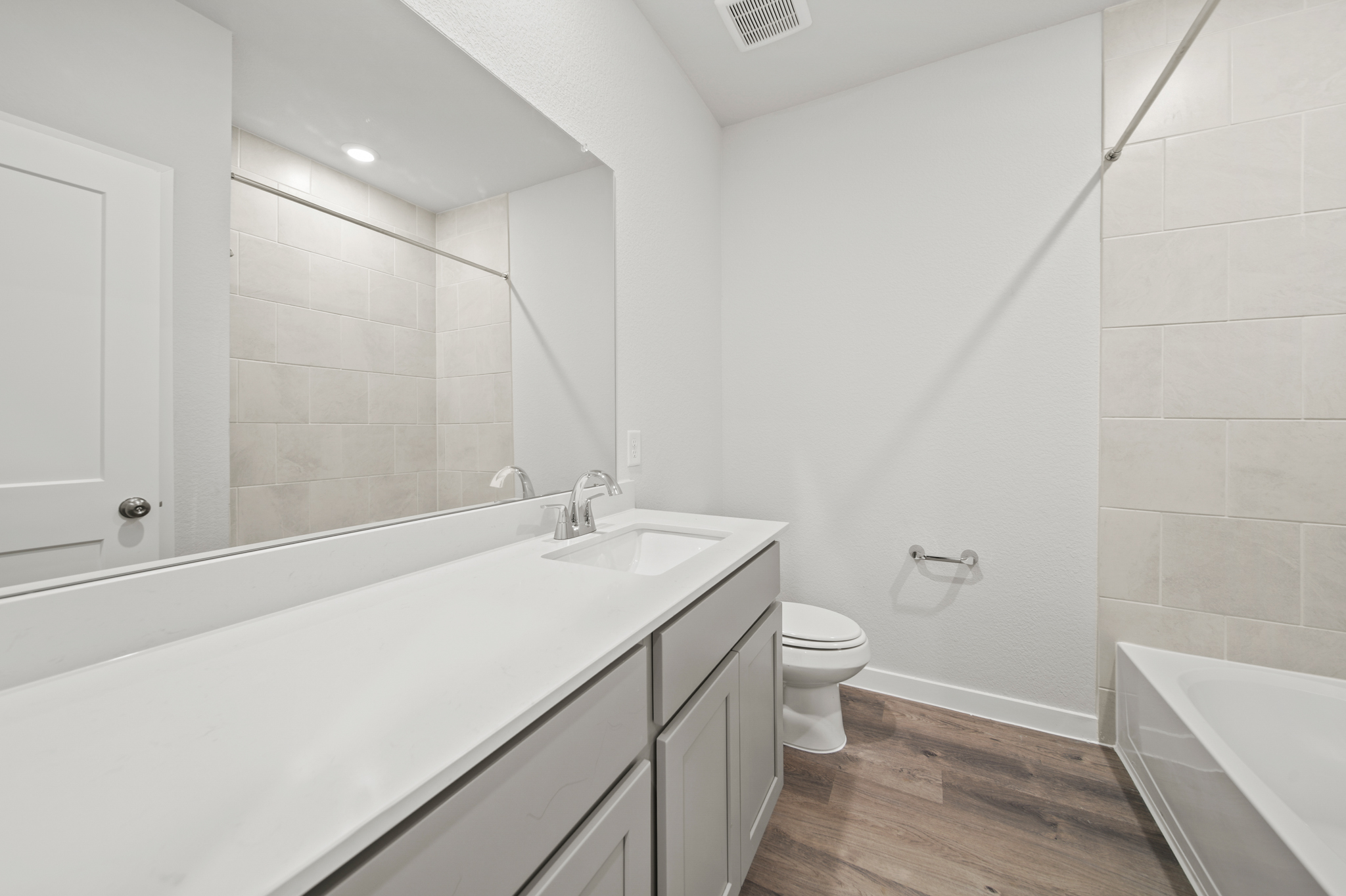 A bathroom with a tub sink and toilet.