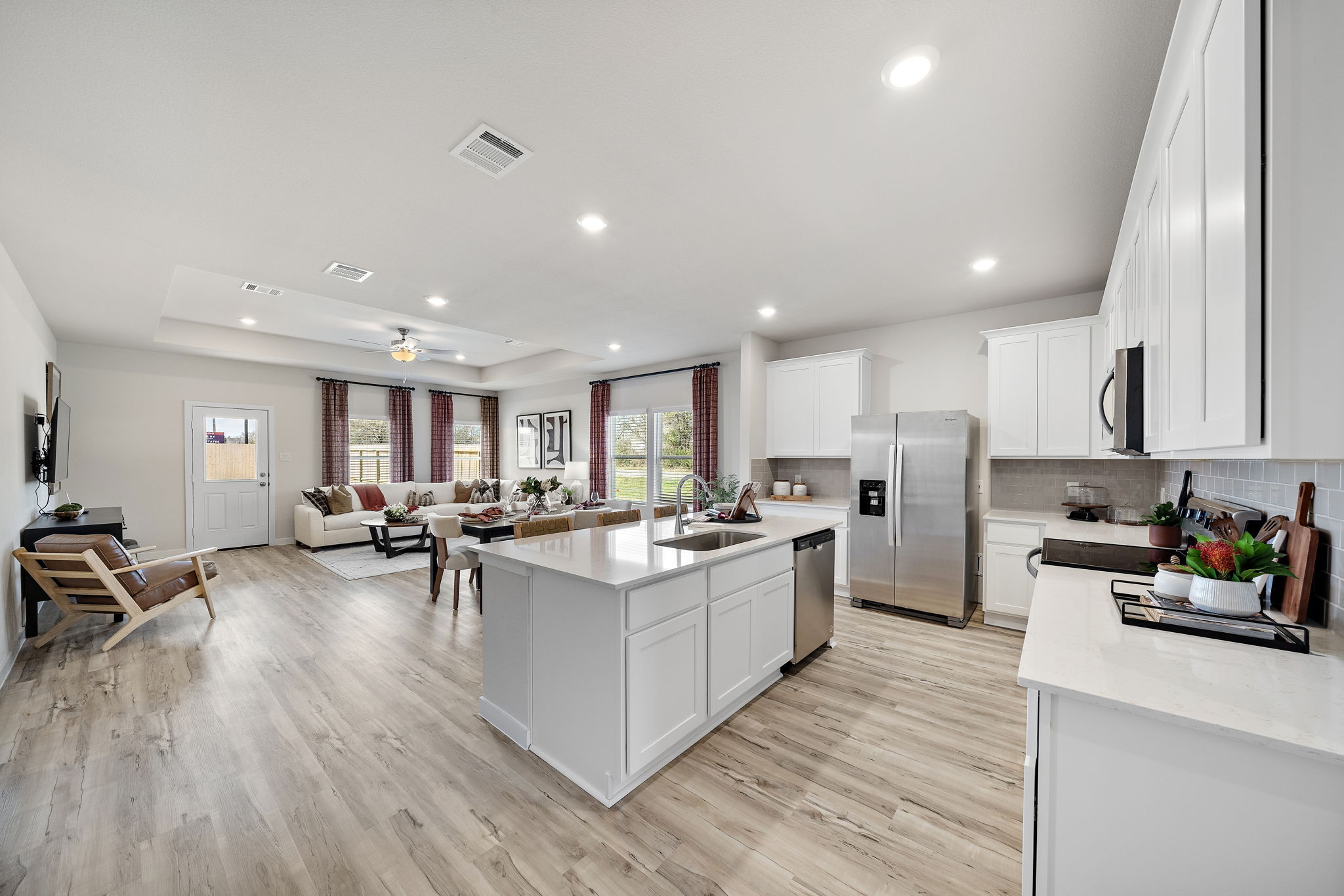 A kitchen with white cabinets.