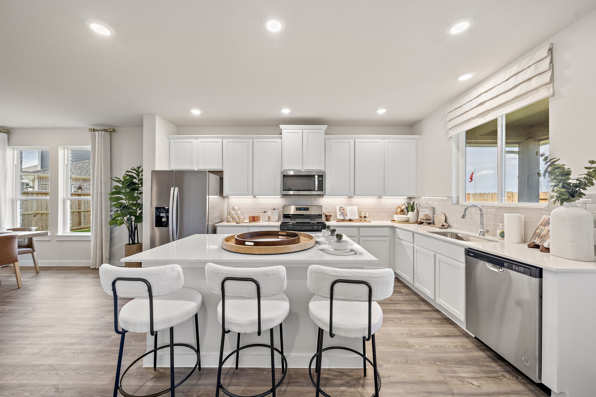 A kitchen with a table and chairs.