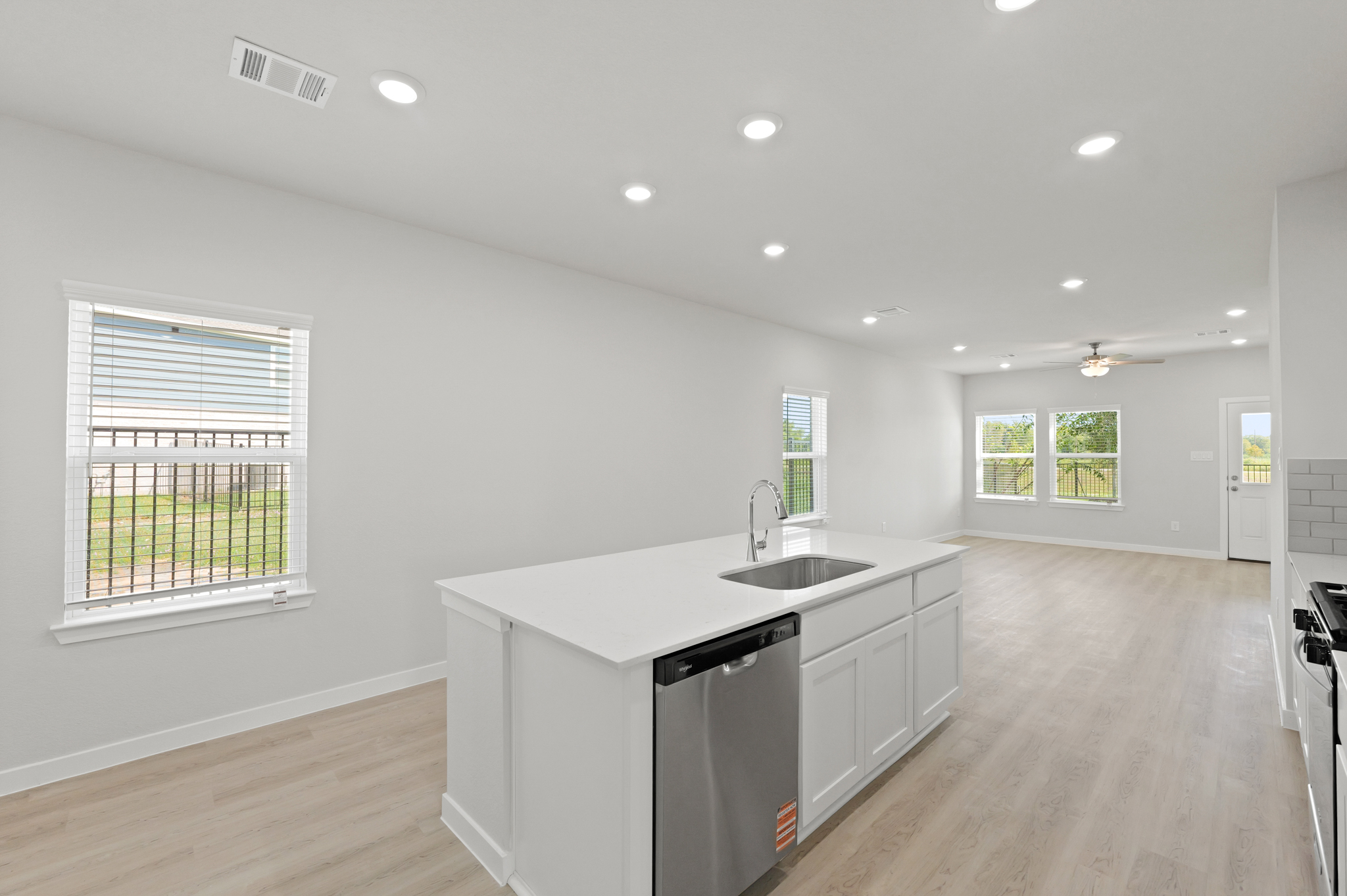 A kitchen with white cabinets.