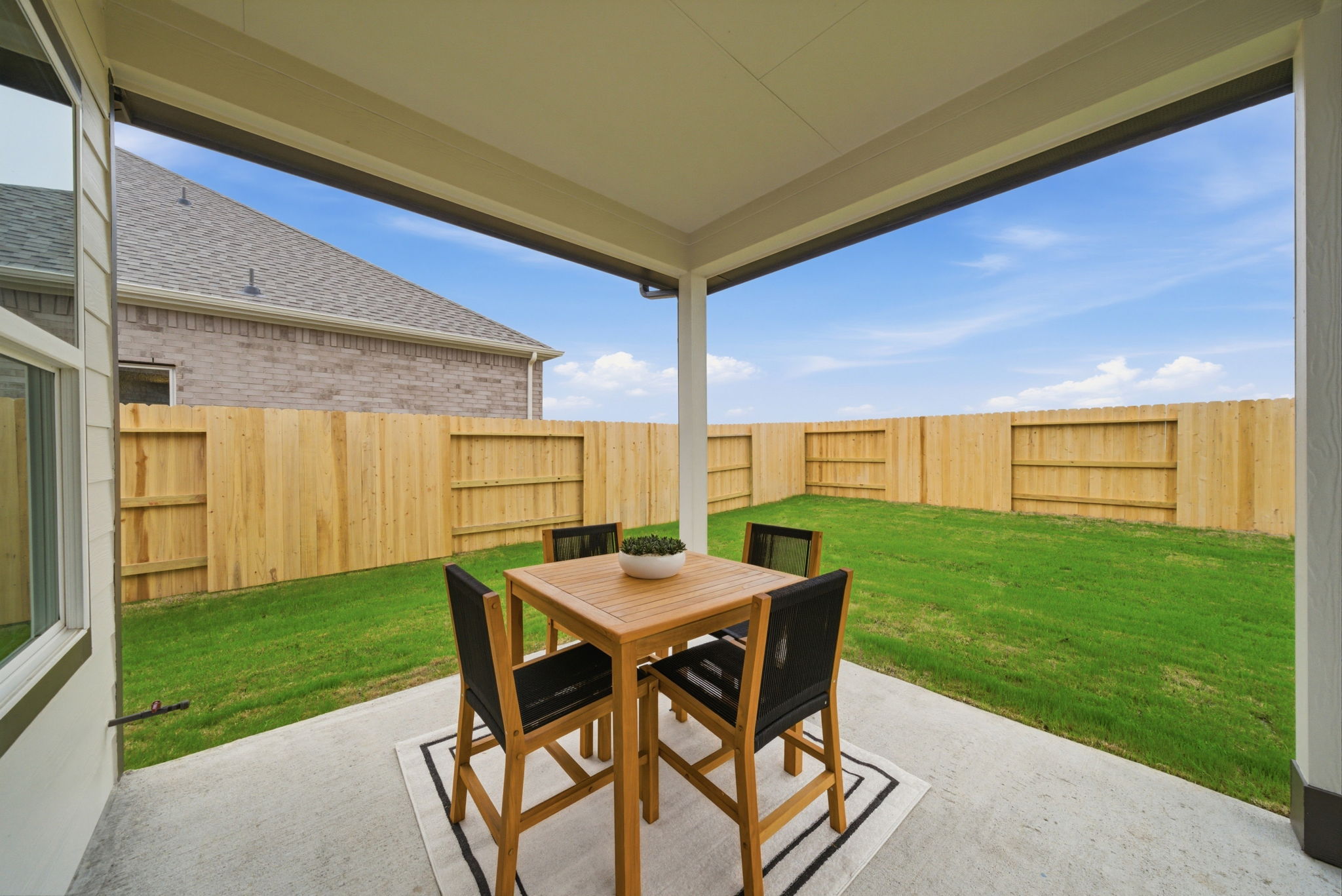 A table and chairs on a patio.