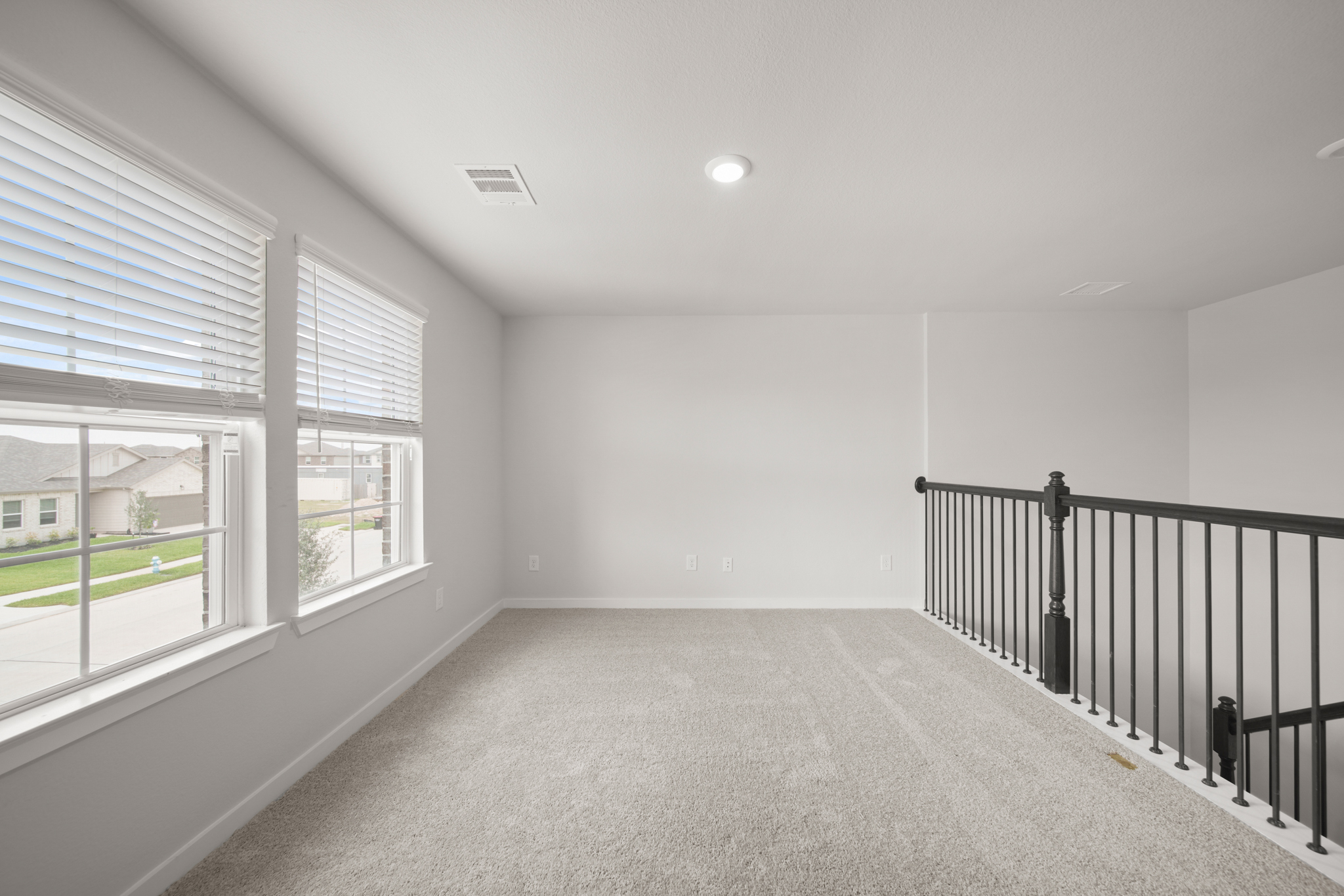 A room with windows and a railing.