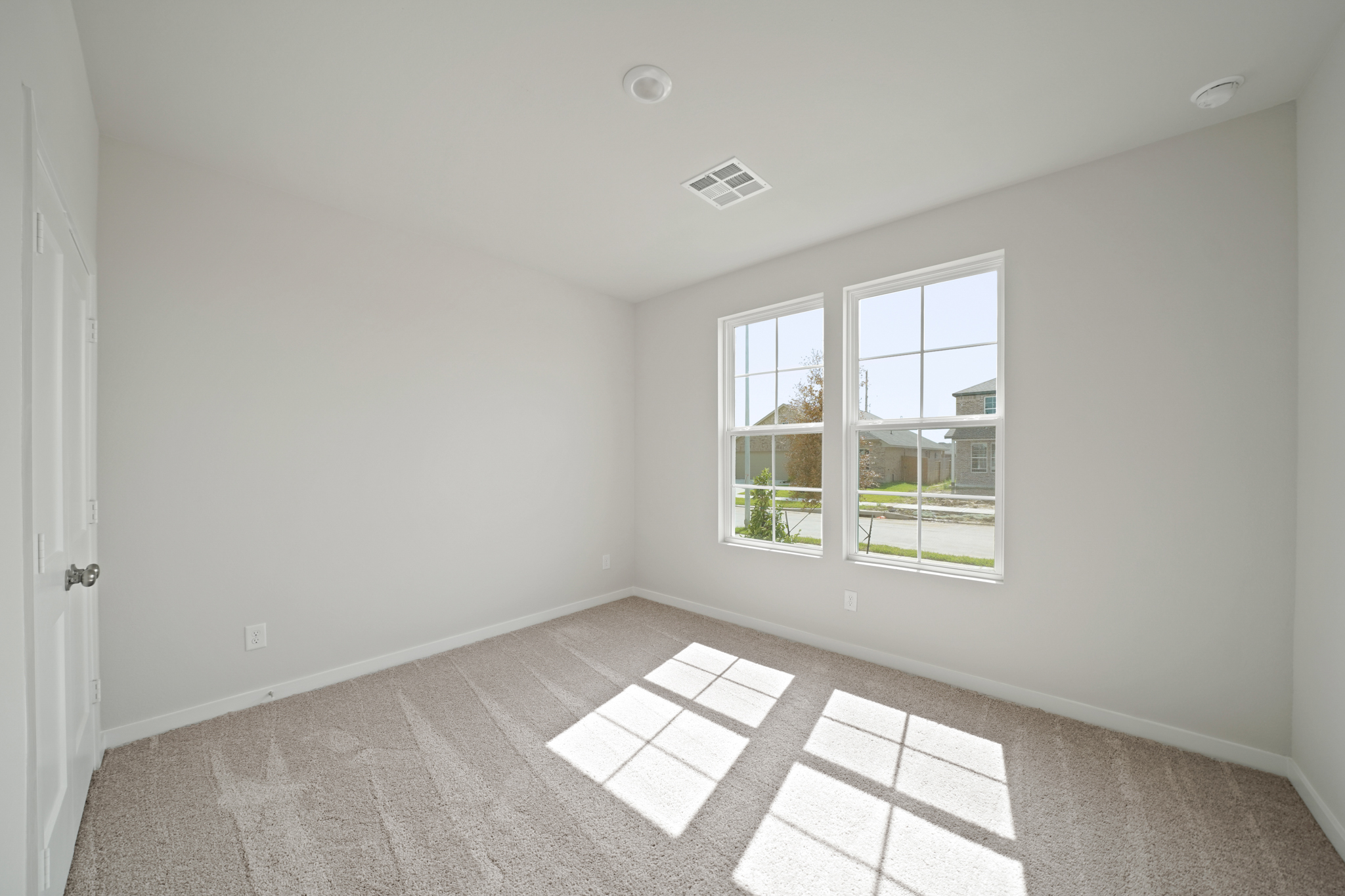 A room with a tile floor and windows.