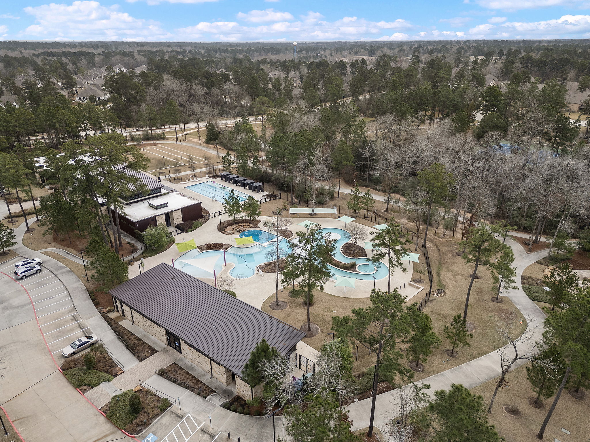 A large swimming pool surrounded by trees.