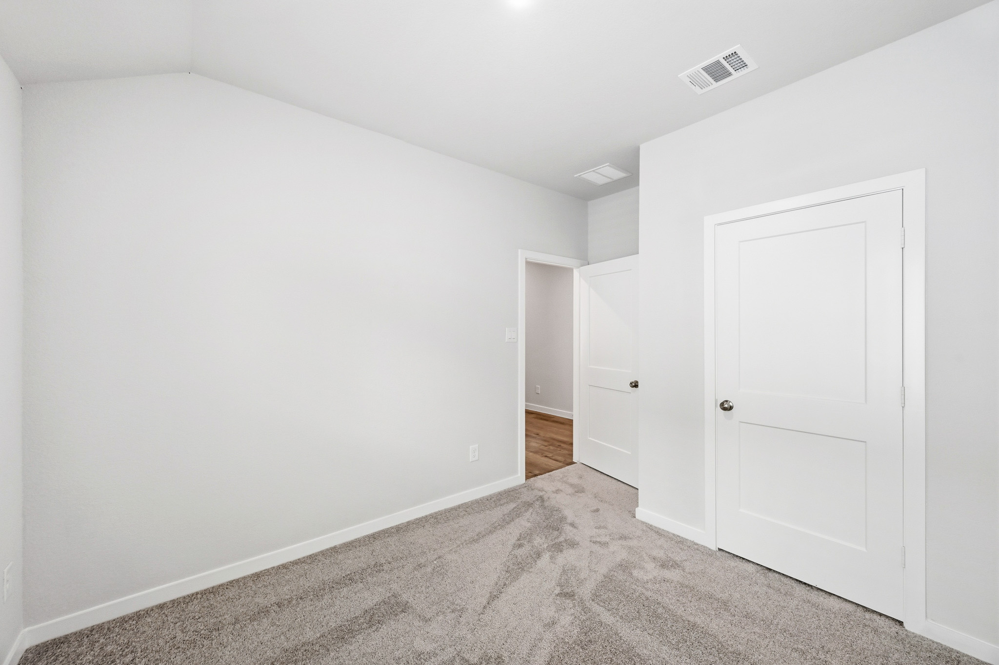 A hallway with white doors.