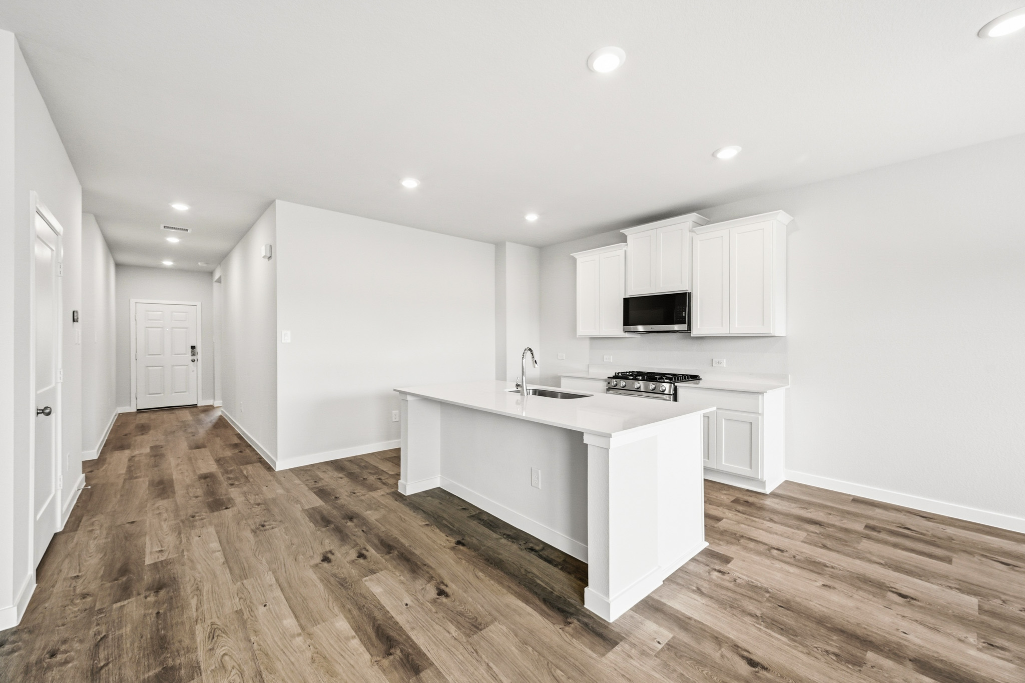 A kitchen with white cabinets.