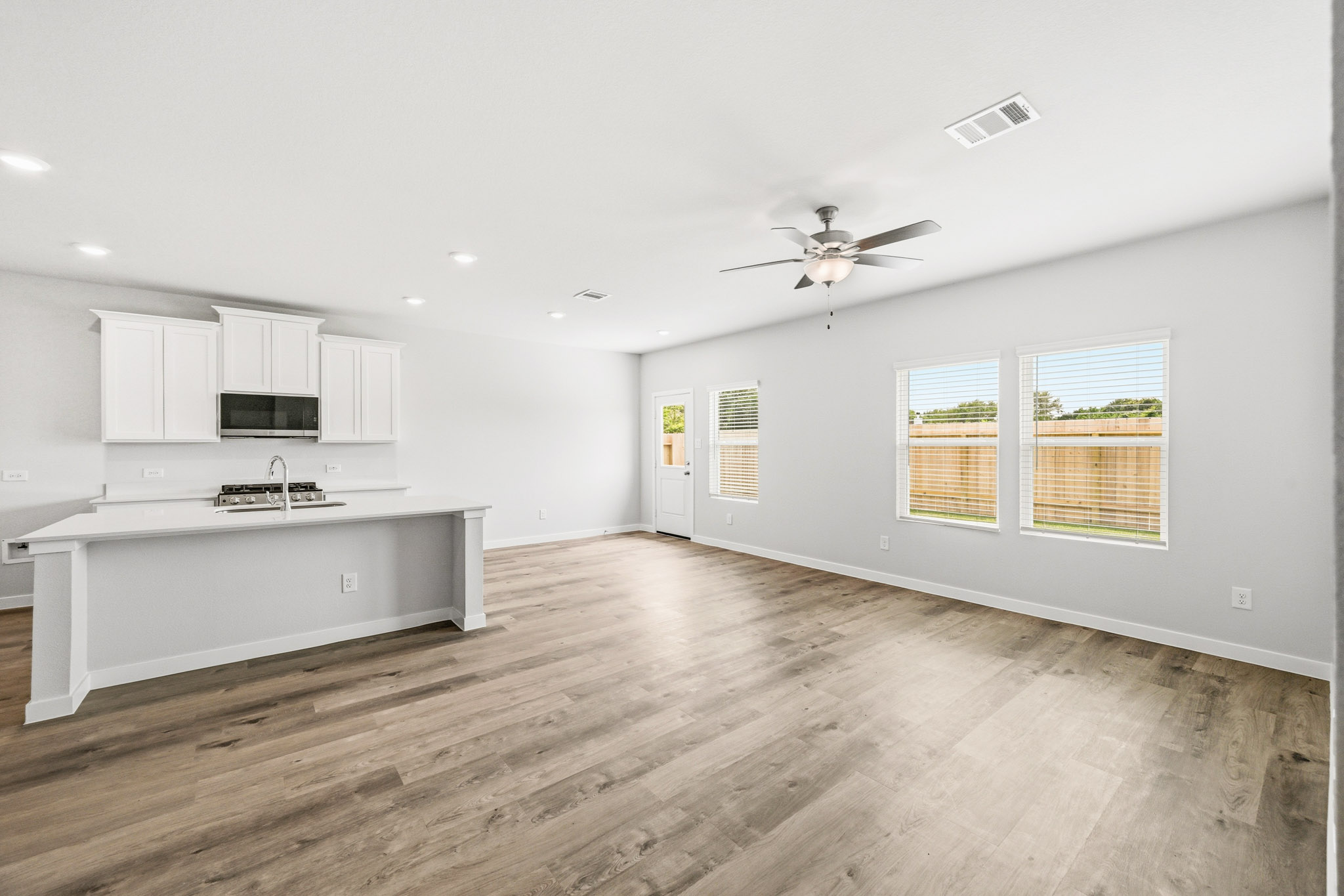 A kitchen with a wood floor.
