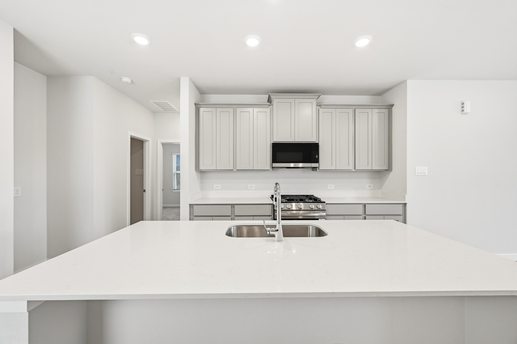 A kitchen with white cabinets.