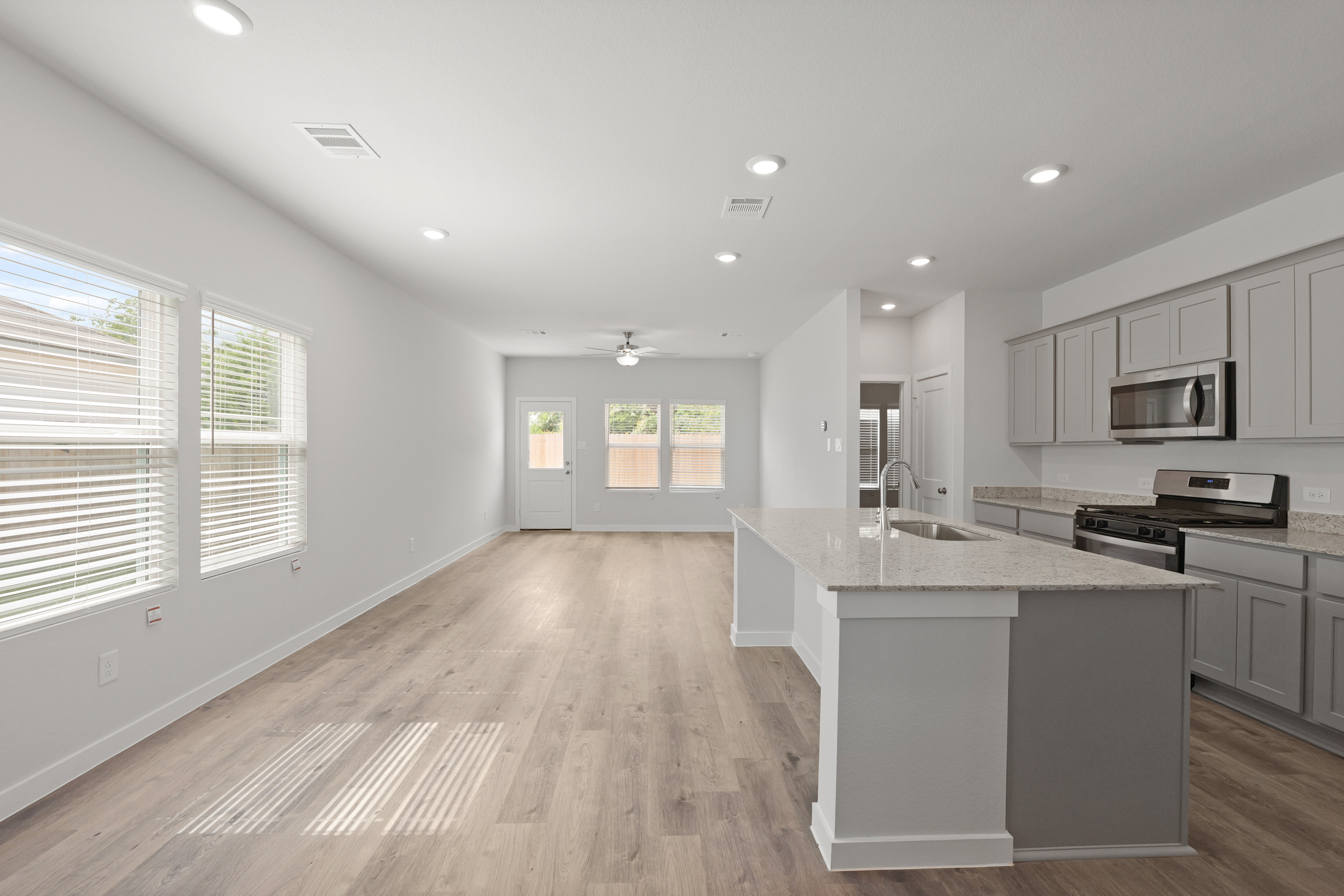 A kitchen with white cabinets.