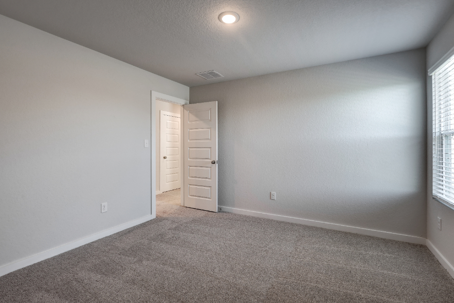 A room with a white wall and a white door.