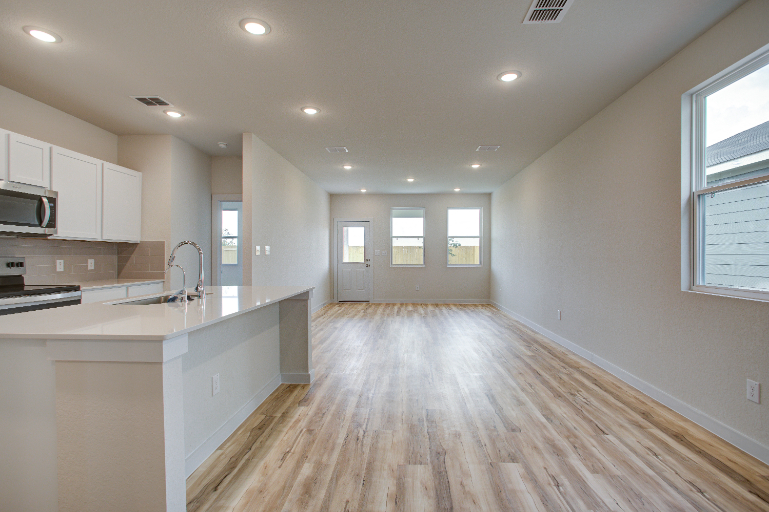 A kitchen with white cabinets.