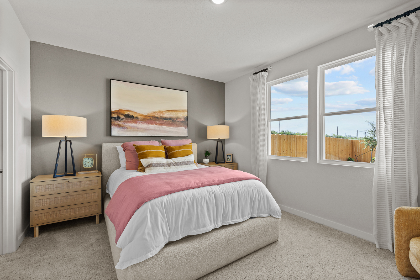 A bedroom with a large window.