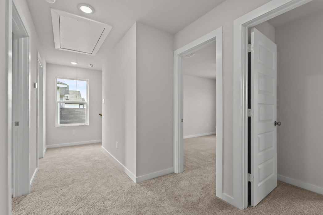 A hallway with white doors.