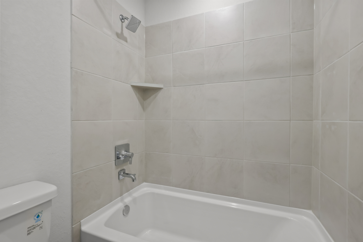 A white tiled bathroom.
