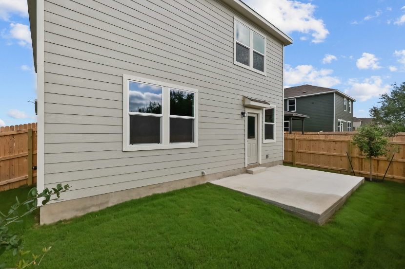 A house with a fence and grass.