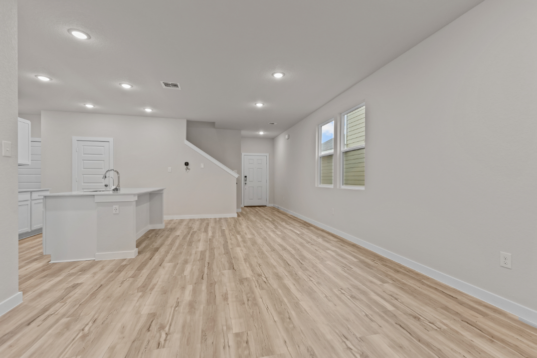 A room with white walls and a wood floor.