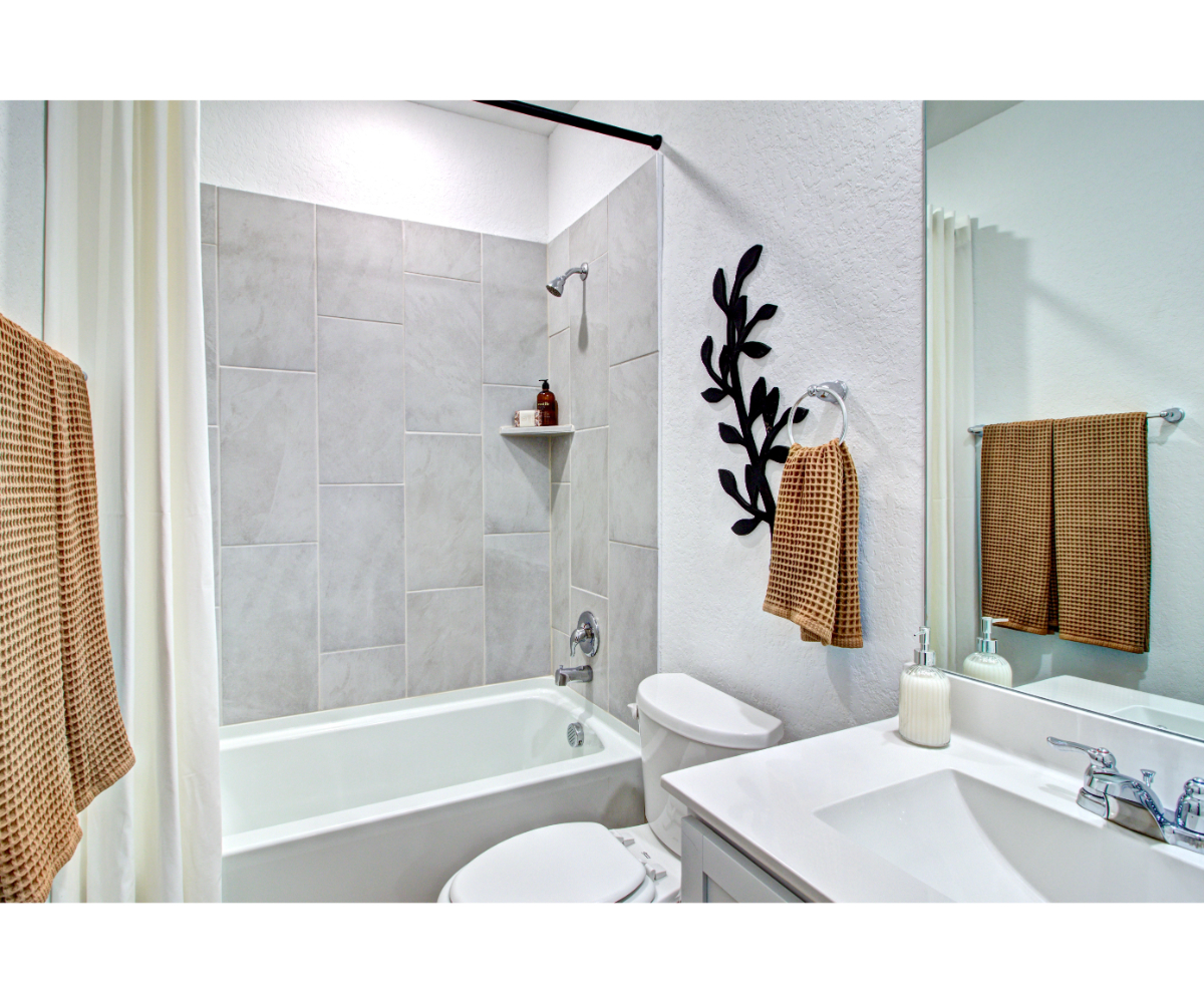 A bathroom with a sink toilet and a bathtub.