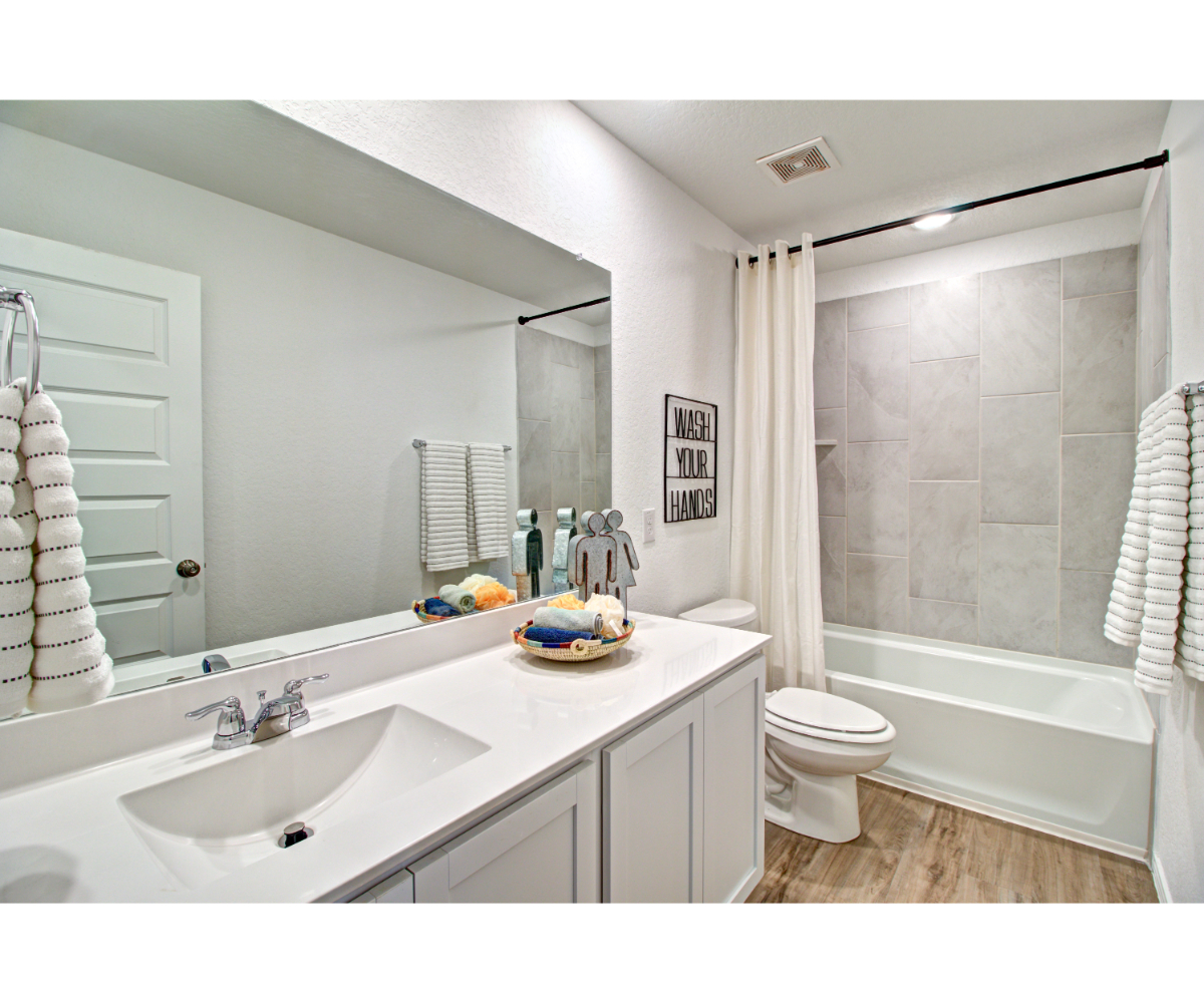 A bathroom with a tub sink and toilet.