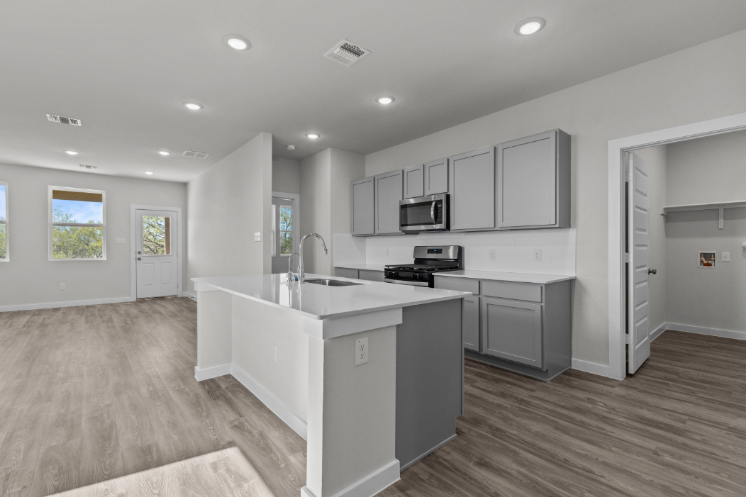A kitchen with white cabinets.