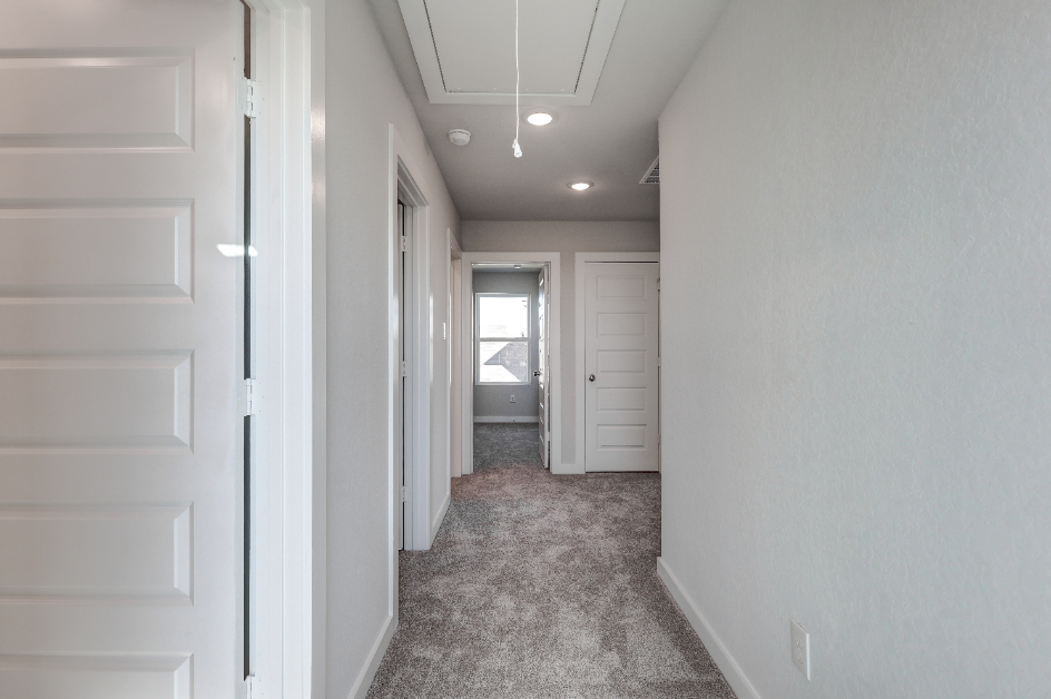 A hallway with white doors.