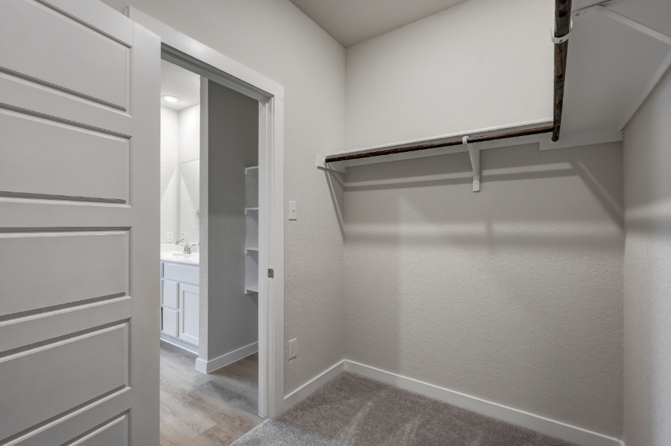 A white room with a sink and a mirror.