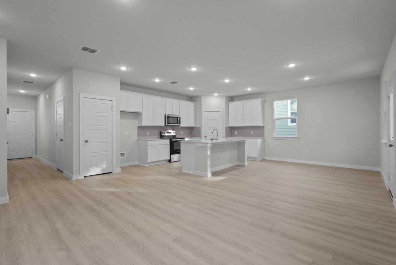 A large kitchen with white cabinets.