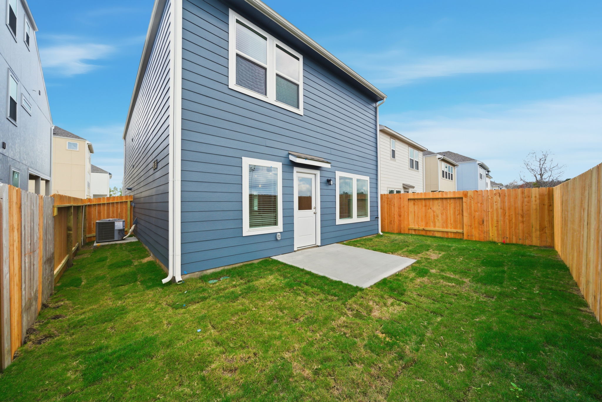 A blue house with a fence around it.