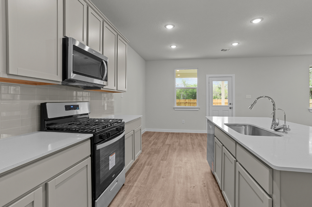 A kitchen with white cabinets.