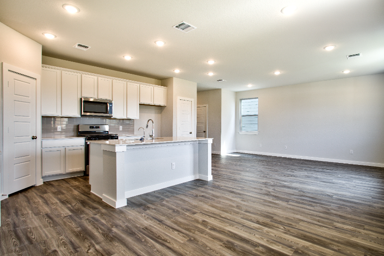 A kitchen with white cabinets.