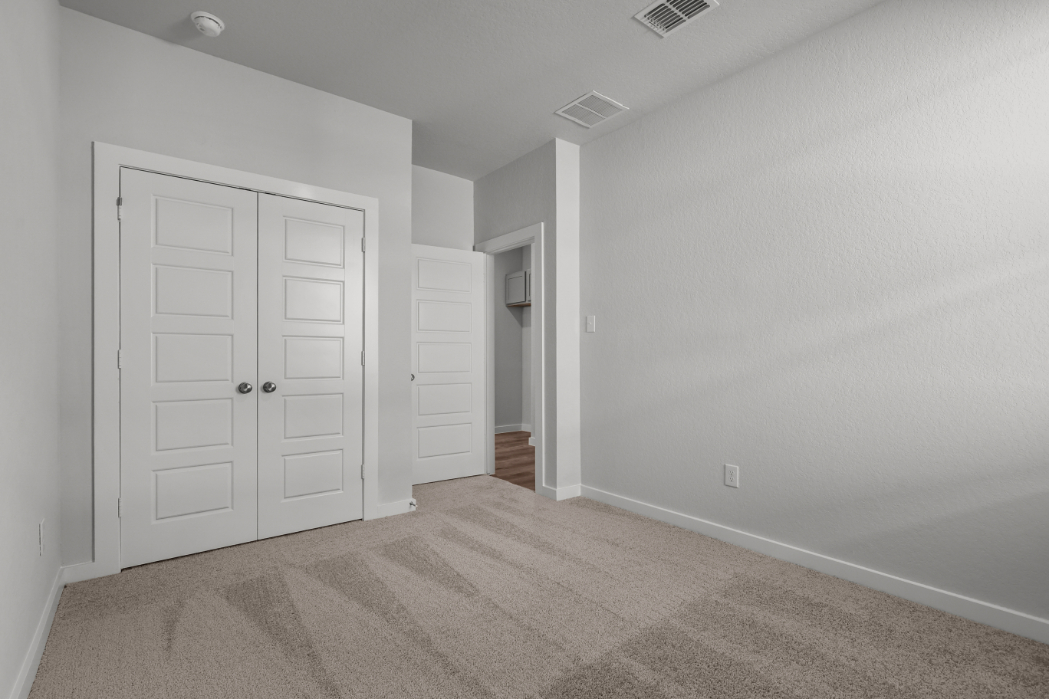 A hallway with white doors.