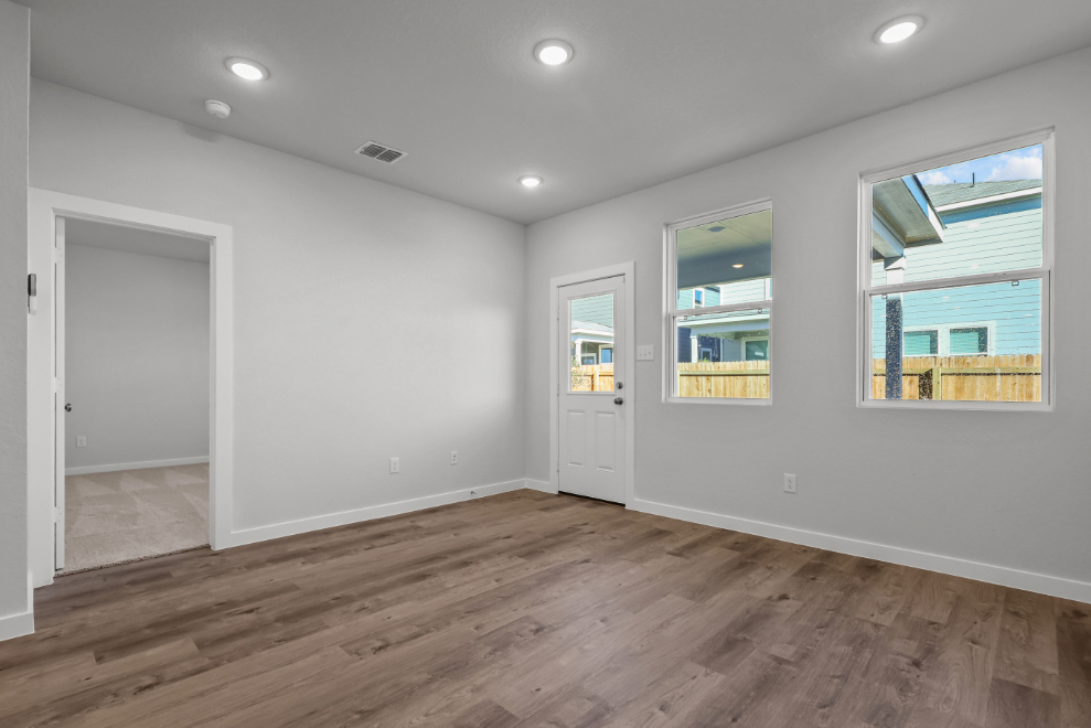 A room with a wood floor and white walls.