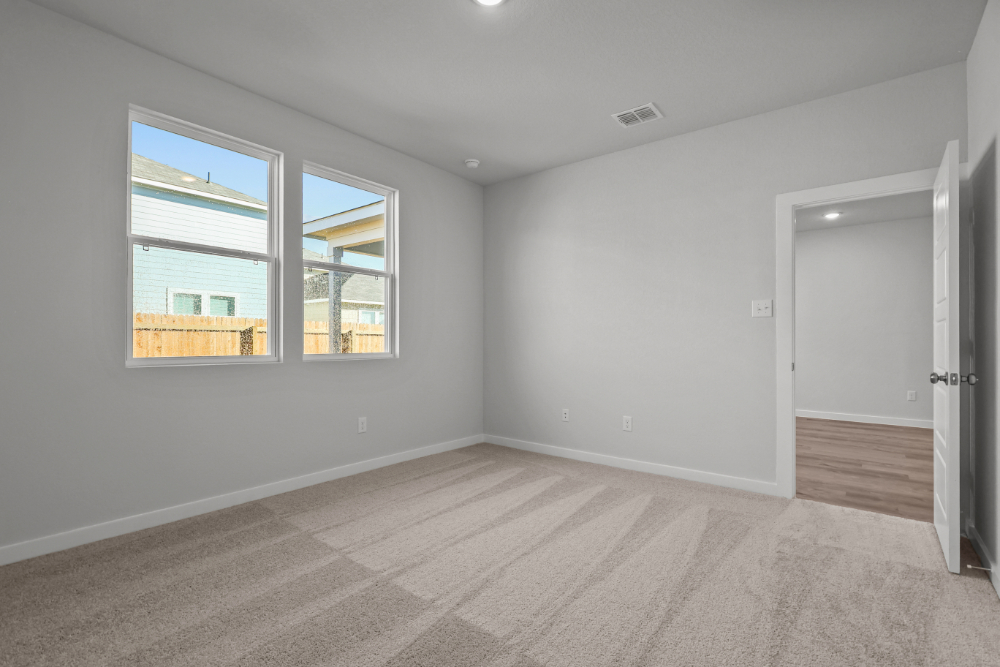 A room with a window and a door.