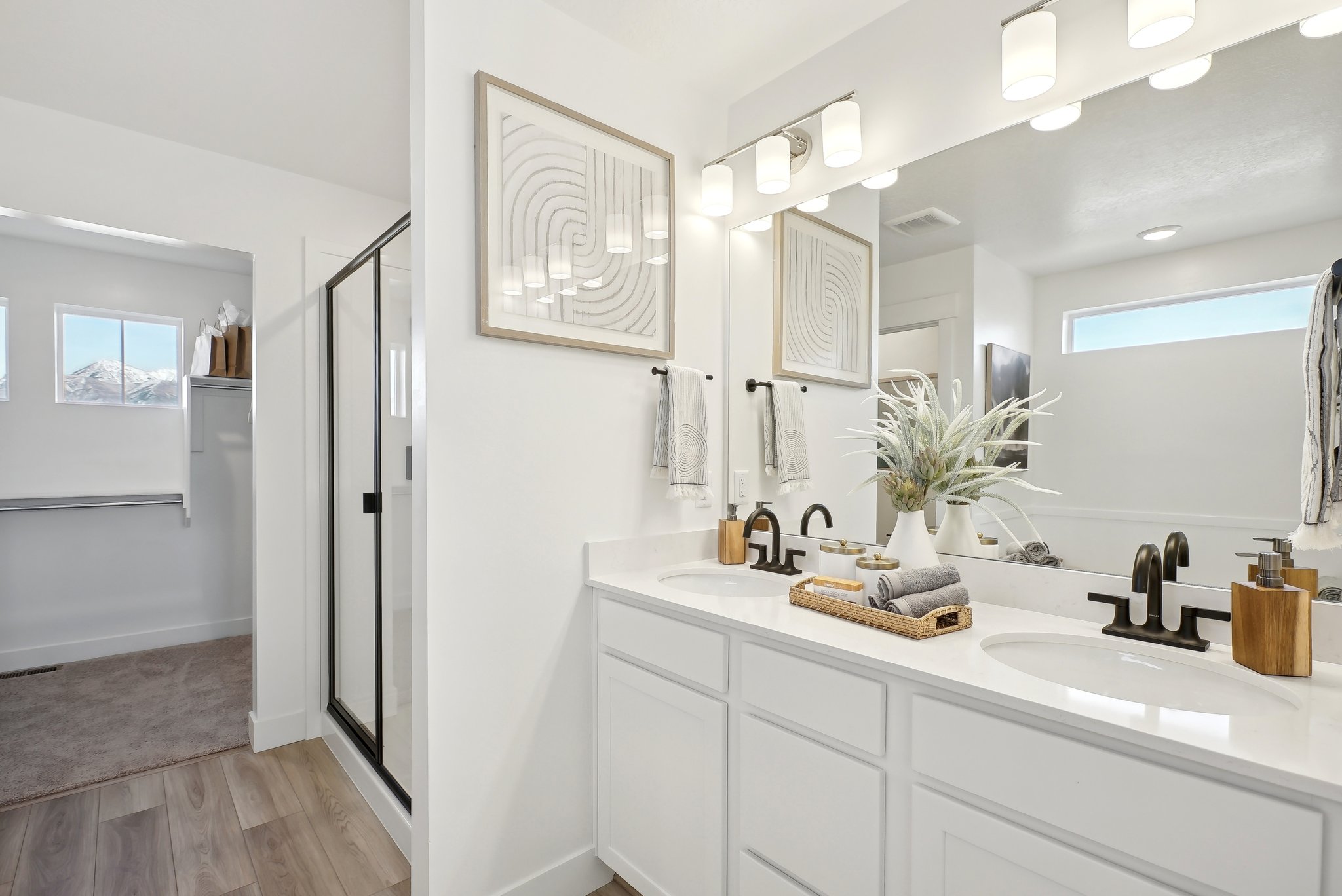 A bathroom with white cabinets.