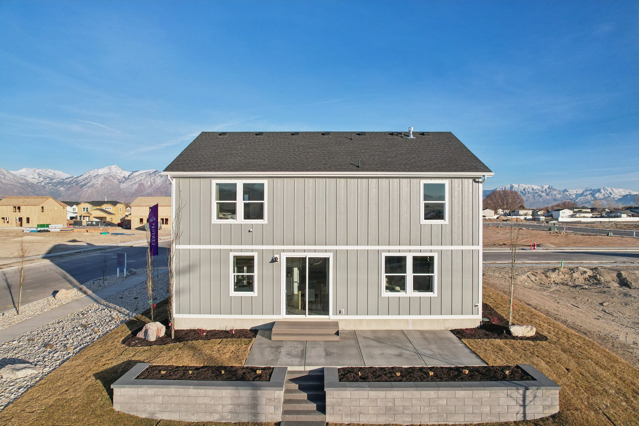 A white building with a black roof.