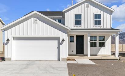 A white house with a garage.