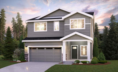 A house with a garage and trees around it.