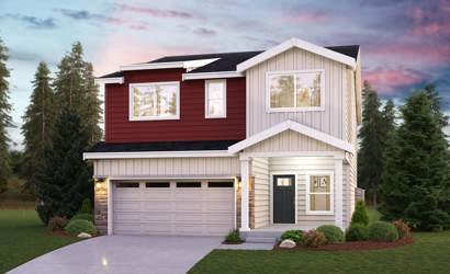 A house with a garage and trees around it.