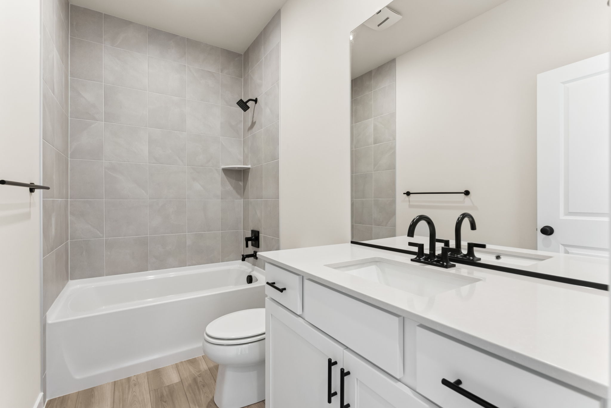 A bathroom with a tub sink and toilet.
