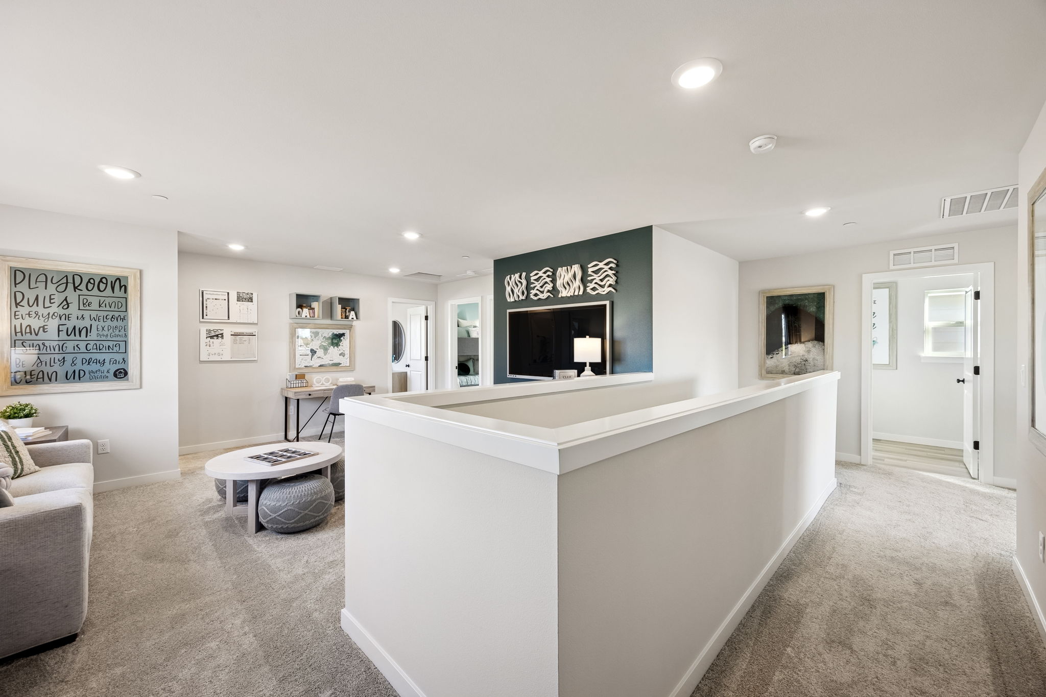 A large white room with a white counter and a white couch.