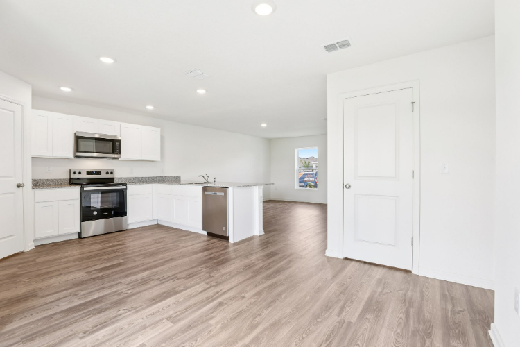 A kitchen with white cabinets.
