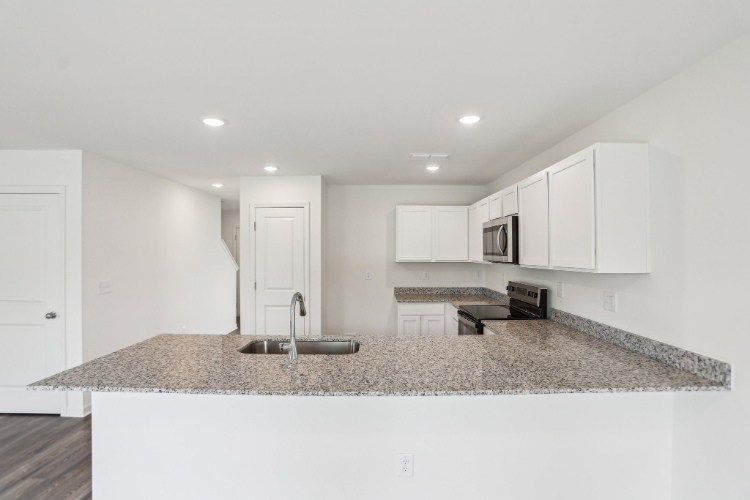 A kitchen with marble counters.