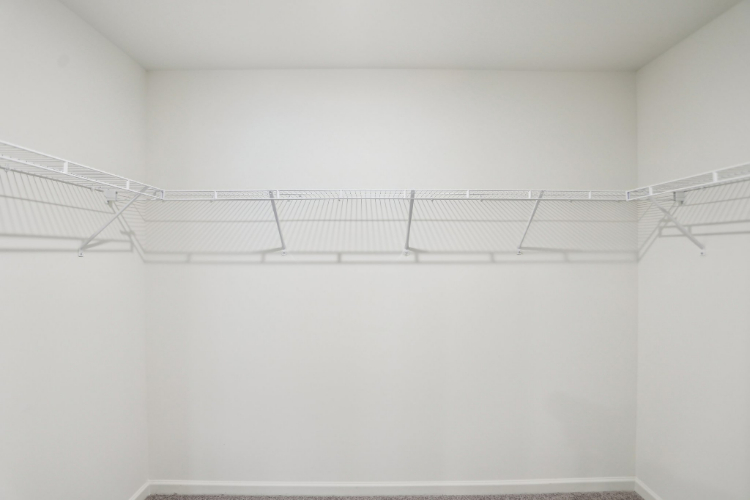 A white wall with a metal railing.