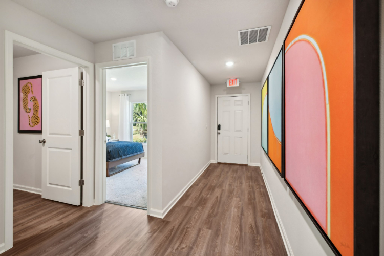 A room with a bed and a mirror.