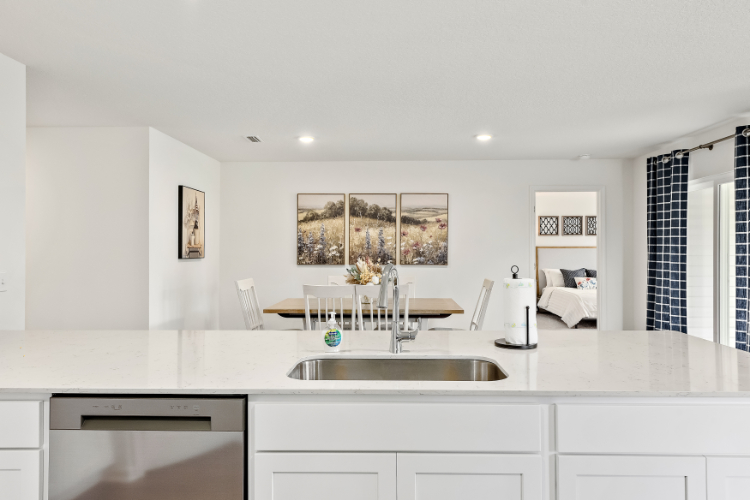 A kitchen with white cabinets.
