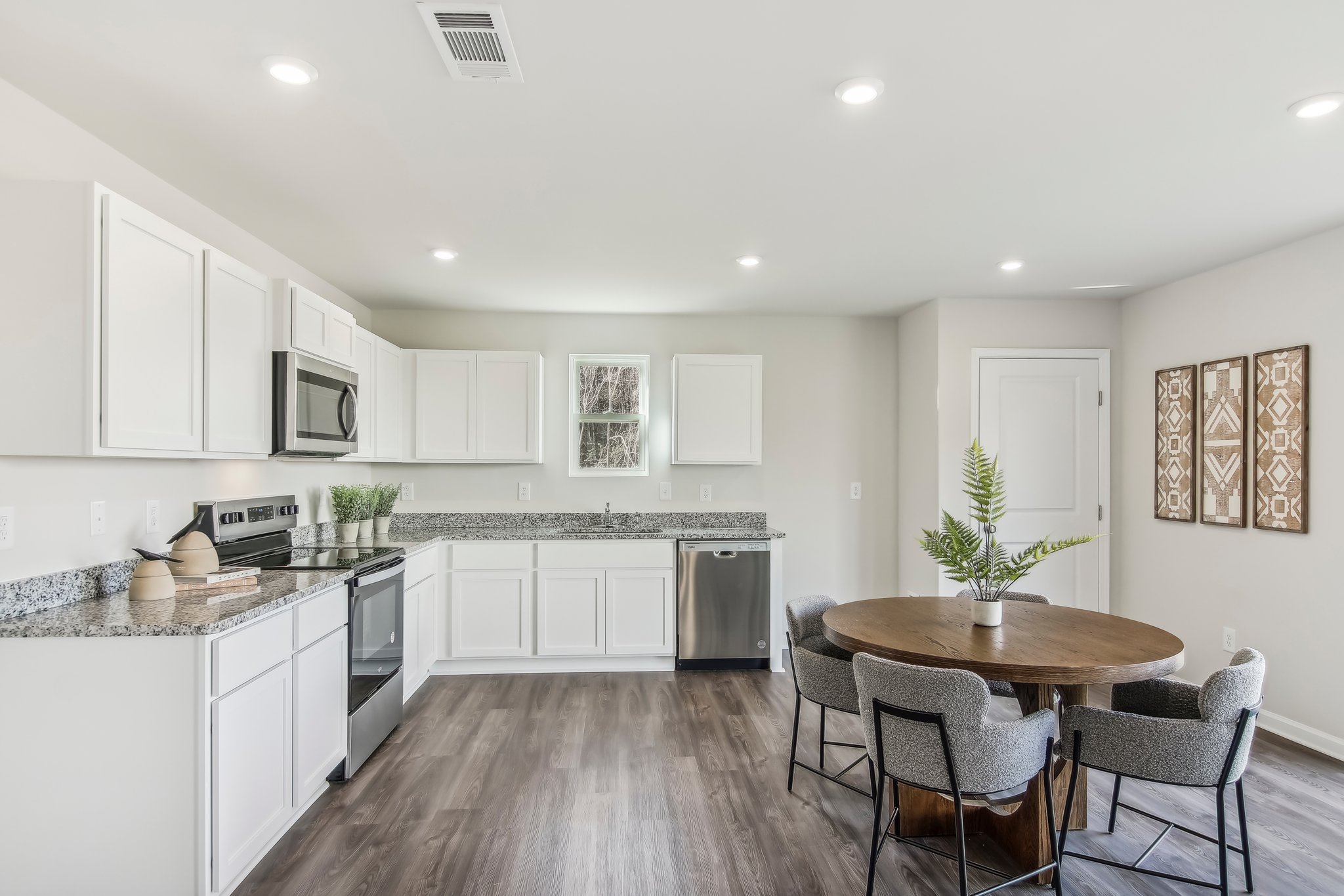 A kitchen with white cabinets.